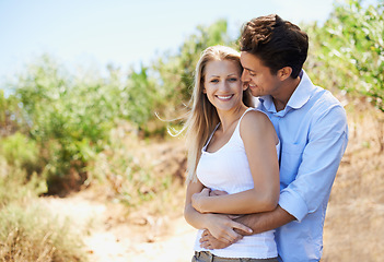 Image showing Couple, portrait and smile in nature with hug in relationship for holiday, vacation or mockup space. Romance, man and woman or happy outdoor in forest with embrace for bonding, love or relax in woods