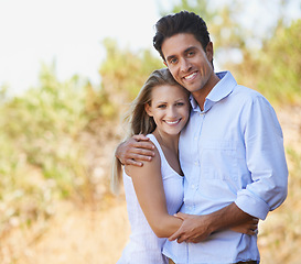 Image showing Happy couple, portrait and hug in nature for embrace, bonding or love in support or outdoor affection. Face of young woman and man smile for comfort, trust or romance in forest or woods together