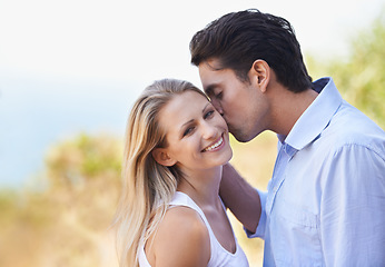 Image showing Happy couple, portrait and kiss in nature for romance, support or affection in outdoor bonding or date. Man and woman with smile on cheek for embrace, comfort or love in forest or woods together