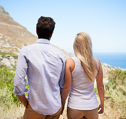 Image showing Couple, holding hands and mountain for hiking, journey or outdoor adventure together. Rear view or back of man and woman in love, commitment or support for trust, holiday or weekend in Cape Town
