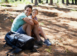 Image showing Couple, hiking break and portrait in nature for outdoor travel, adventure and wellness journey by forest. Happy man and woman relax on ground with backpack for trekking destination, health or fitness