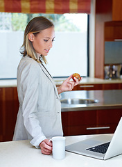 Image showing Woman, coffee and apple by laptop in kitchen for morning, healthy breakfast or diet at home. Female person or freelancer with cup of tea and organic fruit by computer for business, meal or nutrition