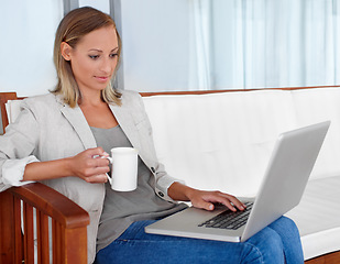 Image showing Laptop, coffee and woman in home for remote work, freelance career and business in living room. House, desk and person on computer for online research, website blog and social networking for job