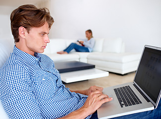 Image showing Man, laptop and remote work in a living room with online career, typing and internet research for job. Home, computer and freelancer with graphic design and technology in a house with email in lounge