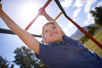 Image showing Child, monkey bars and energy on playground, smiling and obstacle course on outdoor adventure at park. Happy male person, active and exercise on jungle gym, boy and fitness on vacation or holiday