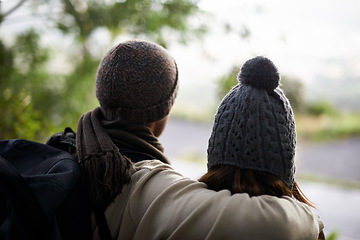 Image showing Nature, hug and couple looking at view on hiking journey, travel adventure or morning backpacking tour. Marriage people, love or back of husband, wife or bonding people embrace on active forest trip