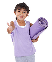 Image showing Portrait, girl and kid with thumbs up, yoga mat and wellness isolated on a white studio background. Model, exercise and child with agreement and healthy with smile and workout with hobby and active