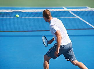 Image showing Sport, man and tennis on court with fitness, competition and performance outdoor with serve and energy. Athlete, player and ball on turf for training, exercise and racket with skill, game or wellness