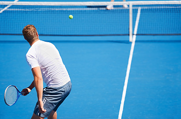 Image showing Sport, man and tennis on court with serve, competition and performance outdoor with fitness and energy. Athlete, player and ball on turf for training, exercise and racket with skill, game and hobby