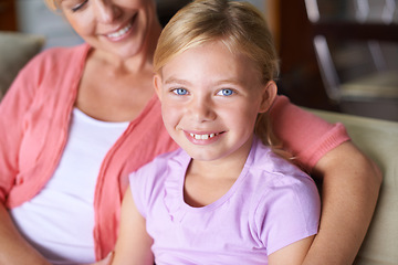 Image showing Mother, girl and relaxing on couch in portrait, bonding and love in childhood by single parent at home. Daughter, mommy and caring together in living room, embrace and security or enjoying connection