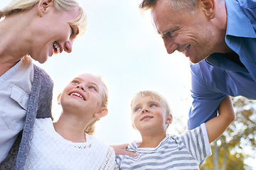 Image showing Happy, parents and children embrace in garden outdoor in summer with love, freedom and huddle on blue sky. Below, family and support kids with smile in backyard at home with mother and father