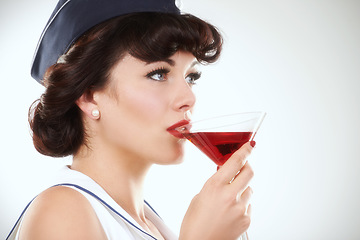 Image showing Glass, stewardess and woman drink alcohol in studio isolated on a white background mockup space. Martini cocktail and an air hostess, vintage pin up girl model or flight attendant travel on journey