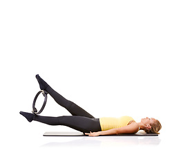 Image showing Pilates ring, legs and woman training in studio isolated on a white background mockup space. Exercise, person on mat and yoga circle for feet, balance and fitness for healthy body workout on floor