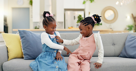 Image showing Kids, play and couch in a home with poke, smile and happy from sibling bonding together. House, lounge sofa and daughter friends with game and girl friendship with fun and youth in a living room