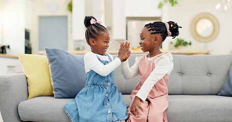 Image showing Kids, high five and couch in a home with young, smile and happy from sibling bonding together. House, lounge sofa and daughter friends with talk and girl friendship with fun and youth in living room