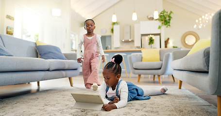 Image showing Black girl children on ground with tablet and relax, elearning or watch cartoon movie, sisters at home and screen time. Young female kids, streaming online and subscription to education app or film