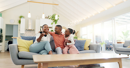 Image showing Support, black family on sofa and in living room of their home happy together smiling. Support or care, happiness or bonding time and African people cuddle on couch in their house for positivity