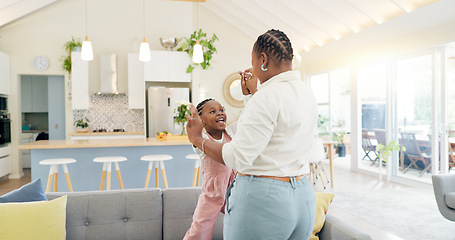Image showing Excited mom, child and dancing in living room with happiness, energy and bonding in home together. Black family, mother and daughter dance on sofa, music and quality time for woman and little girl.