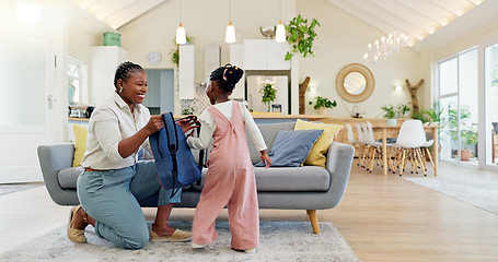 Image showing Talking, happy and a mother with a child getting ready for school in the morning. Kiss, laughing and an African mom helping a little girl with a bag in the living room of a house for kindergarten