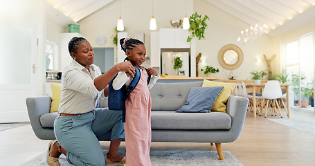Image showing Talking, happy and a mother with a child getting ready for school in the morning. Kiss, laughing and an African mom helping a little girl with a bag in the living room of a house for kindergarten