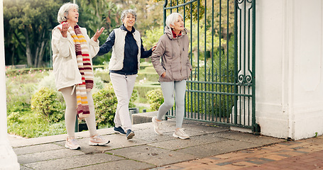 Image showing Senior friends, walking and talking together on an outdoor path to relax in nature with elderly women in retirement. People, happy conversation and healthy exercise in the park in autumn or winter