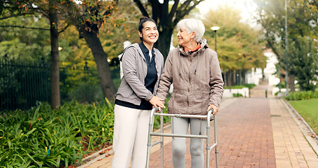 Image showing Senior woman, walker and nurse outdoor in a park with healthcare for elderly exercise. Walking, healthcare professional and female person with peace and physical therapy in a public garden with carer