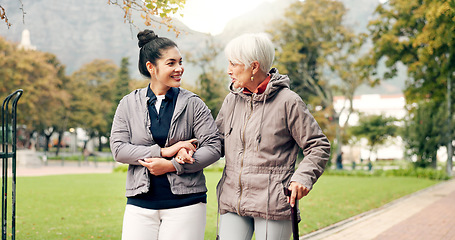 Image showing Senior woman, walker and nurse talking in a park with healthcare for elderly exercise. Walking, healthcare professional and female person with peace and physical therapy in a public garden with carer