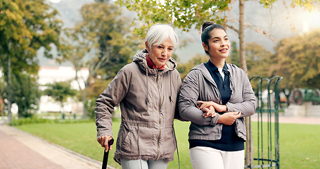 Image showing Senior woman, walker and nurse talking in a park with healthcare for elderly exercise. Walking, healthcare professional and female person with peace and physical therapy in a public garden with carer