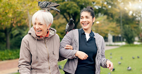 Image showing Senior woman, walker and nurse outdoor in a park with healthcare for elderly exercise. Walking, healthcare professional and female person with peace and physical therapy in a public garden with carer