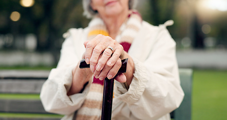 Image showing Walking stick, hands and senior woman closeup on a park bench with person with disability. Mobility support, wellness and balance with cane and elderly female person outdoor in a public garden