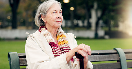 Image showing Relax, thinking and a senior woman at the park for summer, ideas or retirement vision. Smile, remember and an elderly person on a bench in nature with inspiration, memory or outdoor reflection