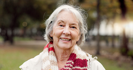 Image showing Senior woman with a smile, portrait in the park and happiness in nature, woods or outdoor for a walk in retirement. Happy, face and elderly person with wellness from exercise or healthy workout