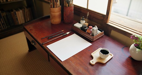 Image showing Ink, paint brush and Japanese art with paper on a desk in a home studio with creativity tools. Creative, painter paperwork and artist with sketch document and calligraphy with pencil and drawing