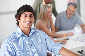 Image showing Design, team and portrait of man in meeting with project, collaboration and creative planning in office. Happy, person and photographer work at table with catalog, portfolio and editing process