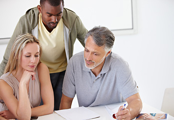 Image showing Coworkers, creative and brainstorming or paperwork for project proposal at agency for problem solving, solution or idea. People, diversity and discussion in boardroom or planning, meeting or support