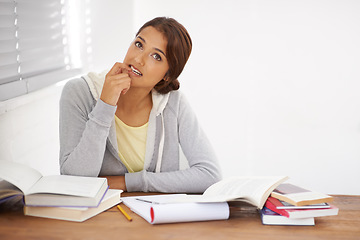 Image showing Student, woman and thinking with books for learning, knowledge or education with idea for study in bedroom..Young person, girl and thoughtful at desk with novel for scholarship, project or assessment