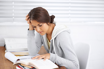 Image showing Student, woman and confused with reading or books for study, knowledge and education with notes for learning..Young person, girl and studying at desk with novel for scholarship, project or assessment