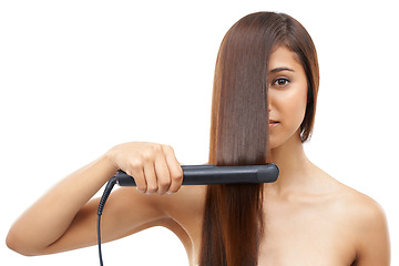 Image showing Hair care, straightener and young woman in studio for cosmetic, salon and beauty treatment. Flat iron tool, confident and portrait of female person with healthy hairstyle routine by white background.