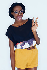 Image showing Fashion, peace sign and portrait of black woman on a white background in trendy, stylish and casual clothes. Hand emoji, hipster style and isolated person with smile, glasses and accessory in studio