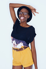 Image showing Fashion, peace sign and black woman on a white background in trendy, stylish and casual clothes. Hand emoji, hipster style and isolated person with tongue out, glasses and cool accessory in studio