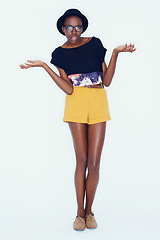 Image showing Shrugging, question and portrait of woman with fashion and confused with choice in studio background. Thinking, why and African person with doubt in decision with hipster style and creative outfit