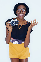 Image showing Black woman, photographer and portrait in studio with happiness, creativity and camera for talent and creative artist career. Young person, smile and face for photoshoot and lens by white background