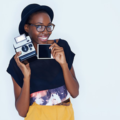 Image showing Happy woman, polaroid and portrait in studio with camera, creativity and media for artist with creative talent. Young photographer, happiness and face by vintage image and focus by white background