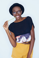 Image showing Portrait, funny and black woman with fashion, silly and stylish clothes on a white studio background. African person, model and girl with glasses and casual outfit, hat and goofy with streetwear