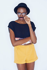 Image showing Funny, black woman and portrait with mustache in studio with hipster fashion and creative model in background. Silly, nerd and geek with goofy style and joke with trendy hat or unique outfit