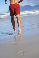 Image showing Man, lifeguard and legs running on beach for security, safety and outdoor swimming emergency. Rear view or back of male person or professional swimmer ready on patrol or rescue at sea or ocean coast