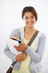 Image showing Portrait, student and smile of woman with books in studio isolated on a white background. Face, textbook and person in university for education, studying knowledge or learning in college in Brazil