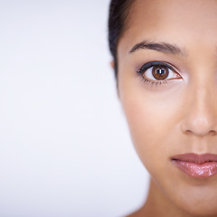 Image showing Half portrait, beauty and space with woman in studio on white background for natural skincare. Face, eye and aesthetic with confident young indian model on mockup for skin wellness or cosmetics