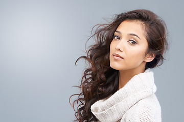 Image showing Hair care, beauty and serious portrait of woman with healthy glow on skin in gray background, studio or mockup. Dermatology skincare and girl with shine in curly hairstyle or treatment in Brazil