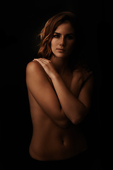 Image showing Woman, body and skin care portrait in studio for beauty, dermatology and shadow with light for art deco aesthetic. Cosmetics model or sexy person with glow and self hug on a dark or black background